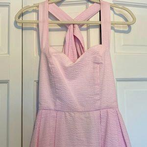 Pink and white striped midi dress. Crossed straps in the back tie together.